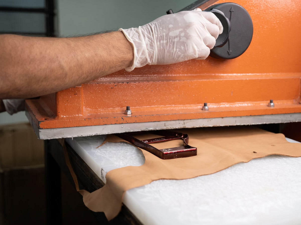 Leather being pressed in the workshop